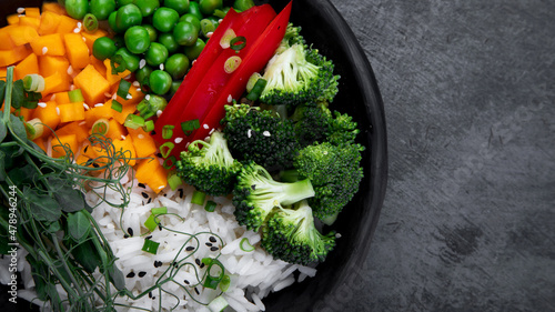 Bowl with rice, broccoli , pumpkin and microgreens.