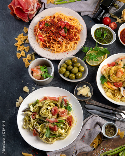 Pasta assortment on dark background. photo