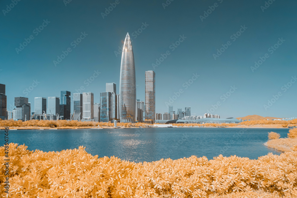 Infrared photography of plants with cityscape by sea