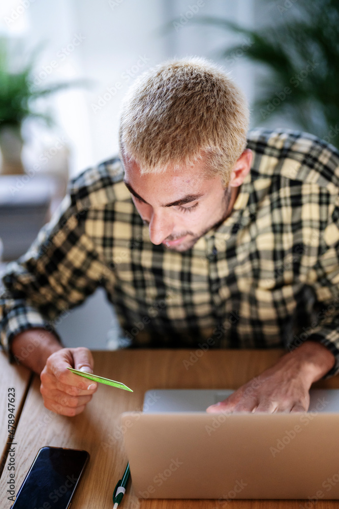 Man paying with plastic card online Man paying with plastic card online