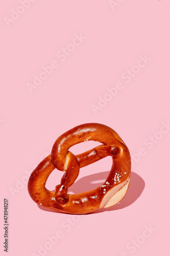 pretzel standing on a pink background