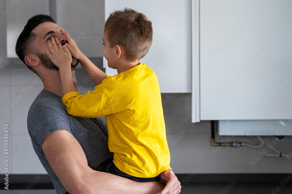 son playing putting his hands on his father's face Stock Photo Adobe