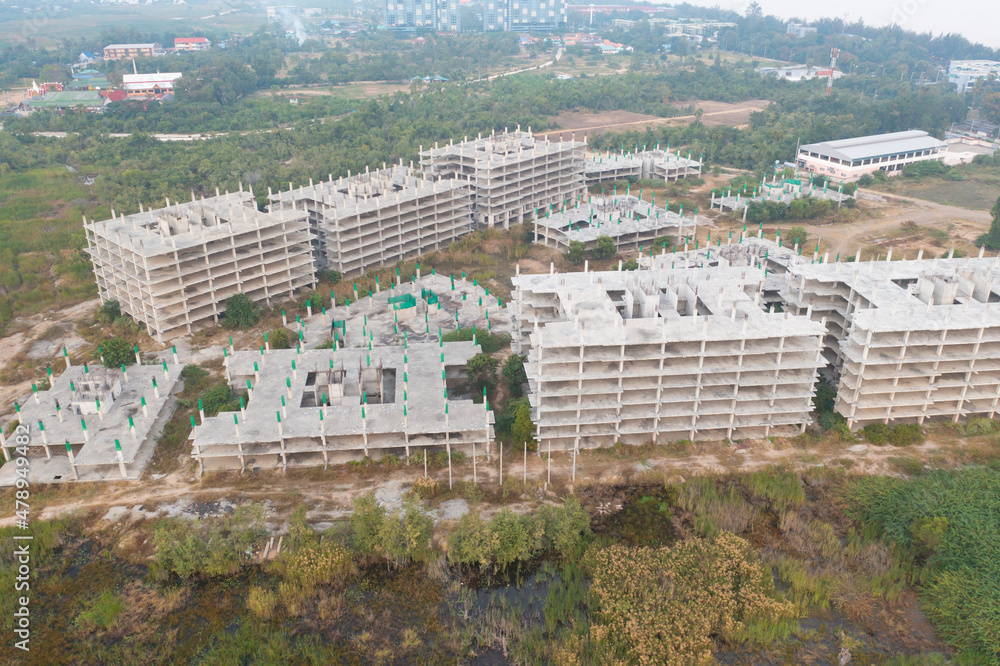 Aerial top view of abandoned apartment or hotel under construction site with structure. Top view of precast concrete slap floor. Development architecture buildings.
