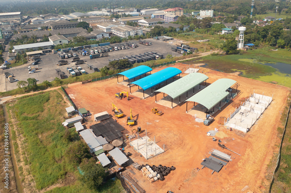 Aerial top view of truck cars parking stock lot row in industry factory, dealer inventory import and export business commercial, Automobile and automotive industry distribution logistic transport