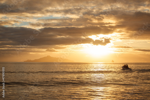 People in a recreational boat head out to sea