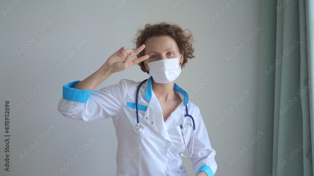 Funny happy female doctor or nurse dancing, celebrating the end of coronavirus pandemic outbreak, medical victory Funny happy female doctor or nurse dancing, celebrating the end of coronavirus pandemic outbreak, medical victory
