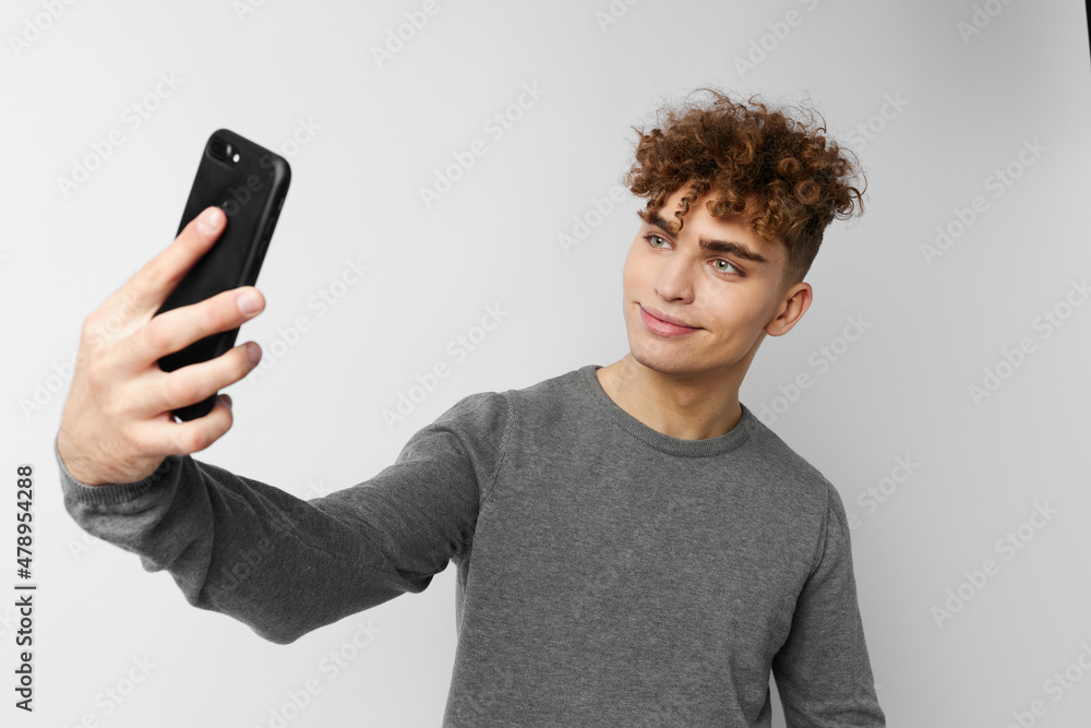 handsome young man technology with phone selfie isolated background handsome young man technology with phone selfie isolated background