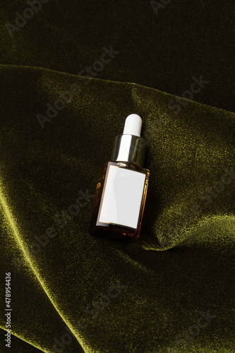 Beauty product on top of green velvet photo