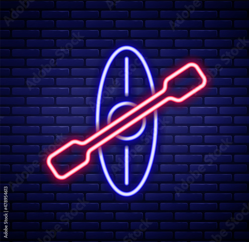 Glowing neon line Kayak and paddle icon isolated on brick wall background. Kayak and canoe for fishing and tourism. Outdoor activities. Colorful outline concept. Vector