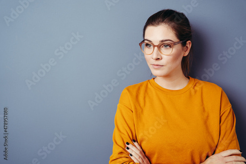 Obraz na plátně Serious worried young woman staring away to the side