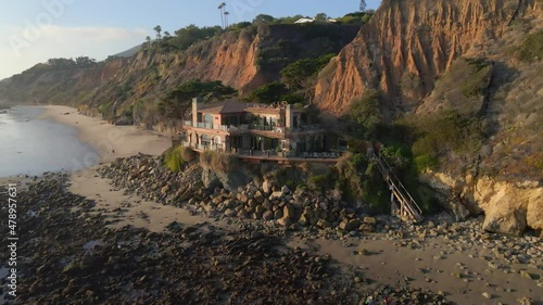 Aerial view Super Luxury home facing the ocean, Expensive real state facing the ocean in El Matador beach state park in Malibu California during golden hour, vacation rentals photo