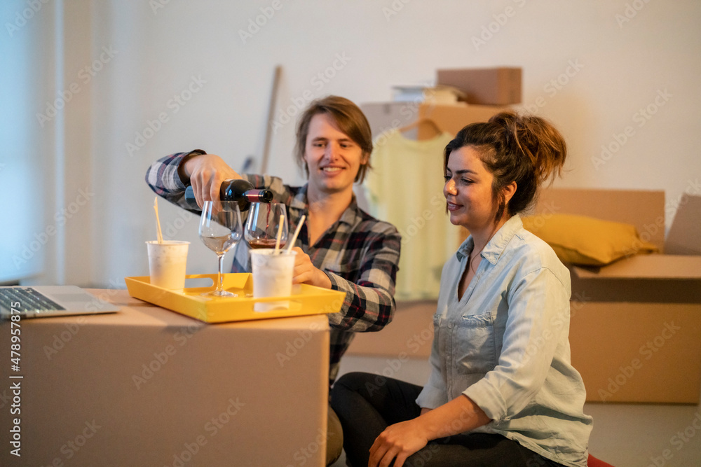 Couple celebrating moving in new apartment Couple celebrating moving in new apartment