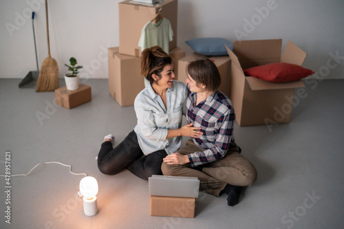 Couple sitting on floor with laptop photo