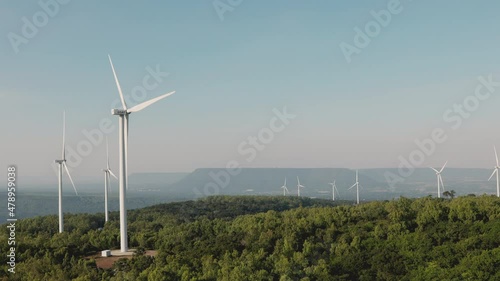 Nakhon Ratchasima/ Thailand-December 6: Rows of EGAT windmills on December 6, 2021. Windmills on the hill convert wind energy to electricity to supply alternative source for electrical usage. photo