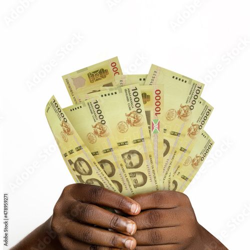 hands holding 3D rendered 10000 Burundian franc notes. closeup of Hands holding Burundian currency notes
