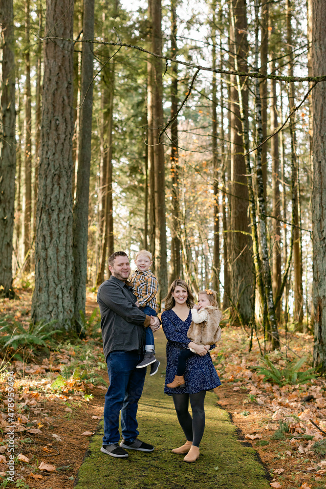 Smiling Mom and Dad with Young Children in Woods Smiling Mom and Dad with Young Children in Woods
