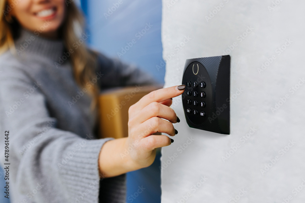 Anonymous woman entering the secret code to open the door Stock Photo ...