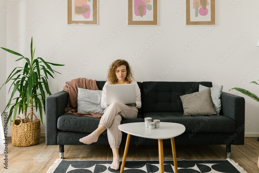 Young Caucasian woman sitting and working from home Young Caucasian woman sitting and working from home