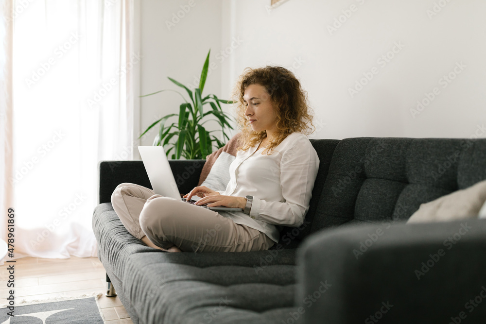 Young female using laptop at home Young female using laptop at home