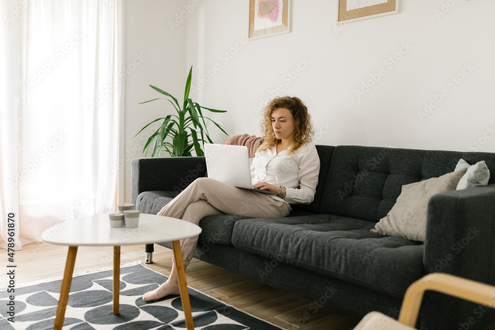 Caucasian woman sitting and studying online from home Caucasian woman sitting and studying online from home