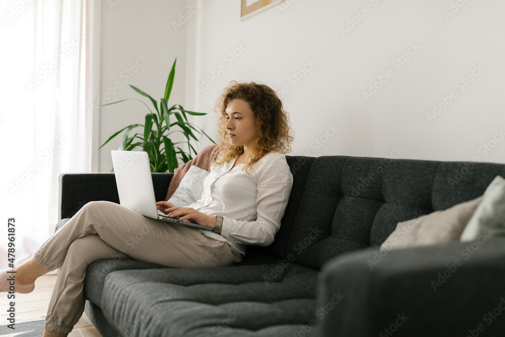 Caucasian female sitting and typing on the laptop Caucasian female sitting and typing on the laptop