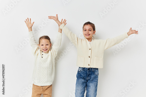 two friends are standing side by side fun childhood light background
