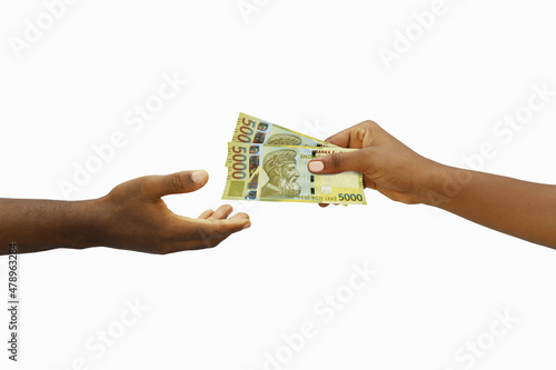 Hand giving 3D rendered 5000 Albanian lek notes to another hand. Hand receiving money photo