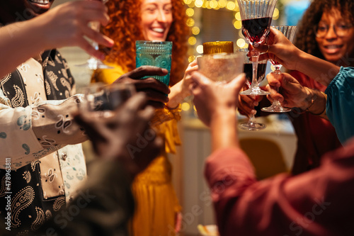 Crop people with wine celebrating Christmas photo