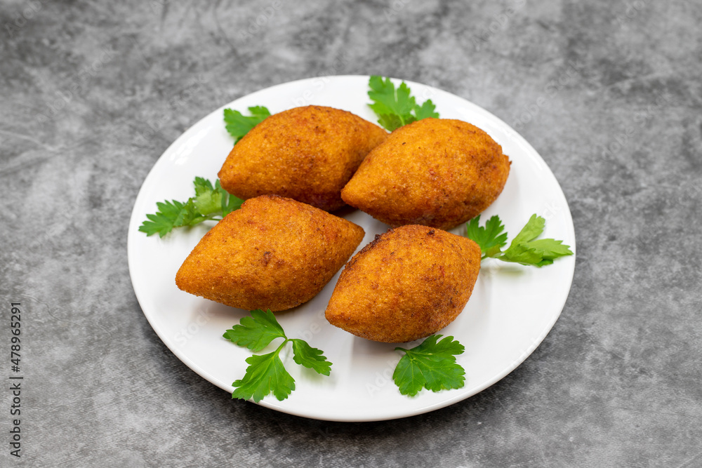 Kibbeh on a dark background. Kibbeh is a popular dish in Middle Eastern cuisine. Stuffed Meatballs Food, Falafel, icli Kofta, Quibe. Horizontal view. Close up Kibbeh on a dark background. Kibbeh is a popular dish in Middle Eastern cuisine. Stuffed Meatballs Food, Falafel, icli Kofta, Quibe. Horizontal view. Close up