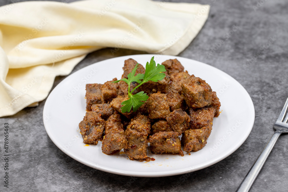 Fried liver cubes on a dark background. Turkish Traditional Food Arnavut Cigeri. Horizontal view. Close up Fried liver cubes on a dark background. Turkish Traditional Food Arnavut Cigeri. Horizontal view. Close up