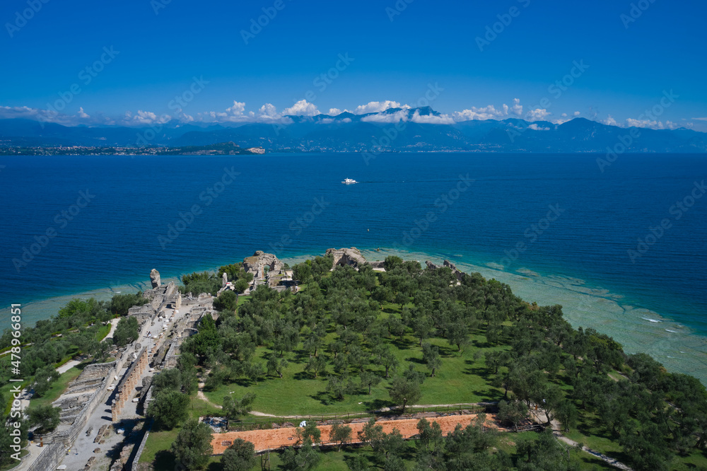 Morning photography with drone. Tourist destination in Lombardy region of Italy. Archaeological site of Grotte di Catullo, Sirmione, Italy early morning aerial view. lake garda.