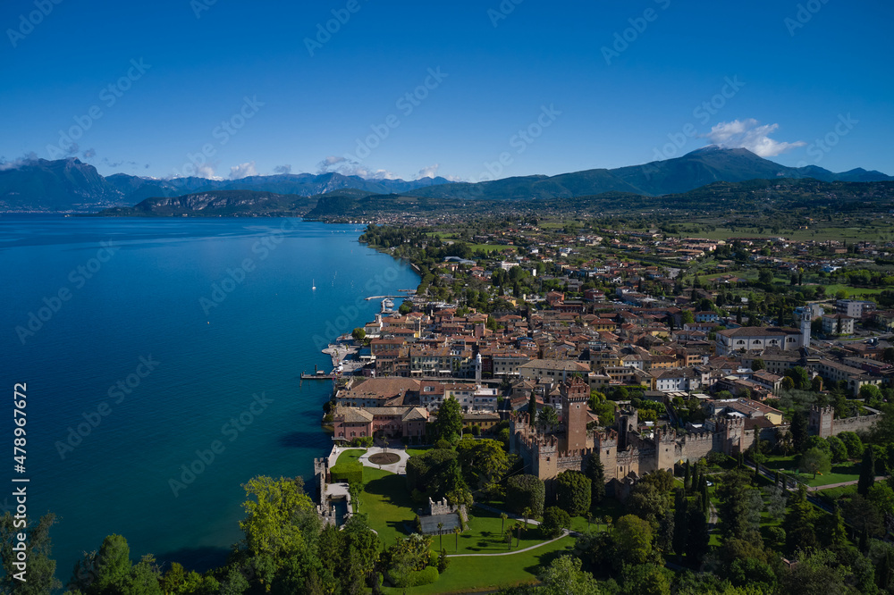 Panorama of the historic town of Lazise. Aerial view of the Scaliger Castle of Lazise. Top view of the historic part of the city Lazise Castle on the coastline of Lake Garda. Lazise Lake Garda Italy