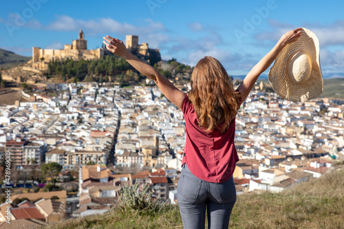 woman travel in europa- view on castle and city landscape