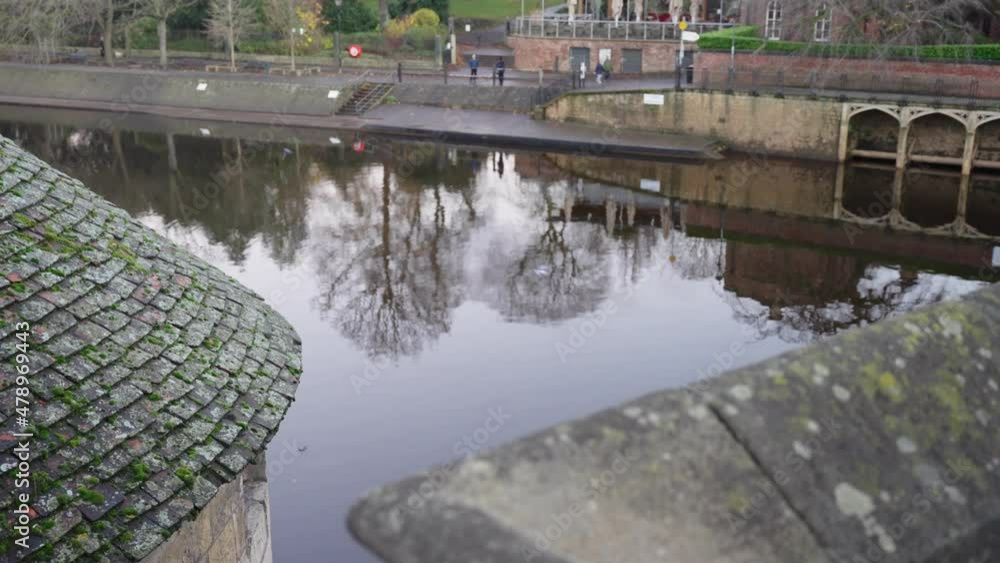 Gimbal parallax of perfectly still river from a bridge in historic city with reflective water and birds gliding Gimbal parallax of perfectly still river from a bridge in historic city with reflective water and birds gliding