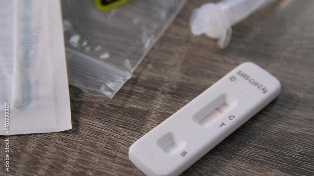 medicine, quarantine and pandemic concept - coronavirus saliva test kit with negative result on table medicine, quarantine and pandemic concept - coronavirus saliva test kit with negative result on table