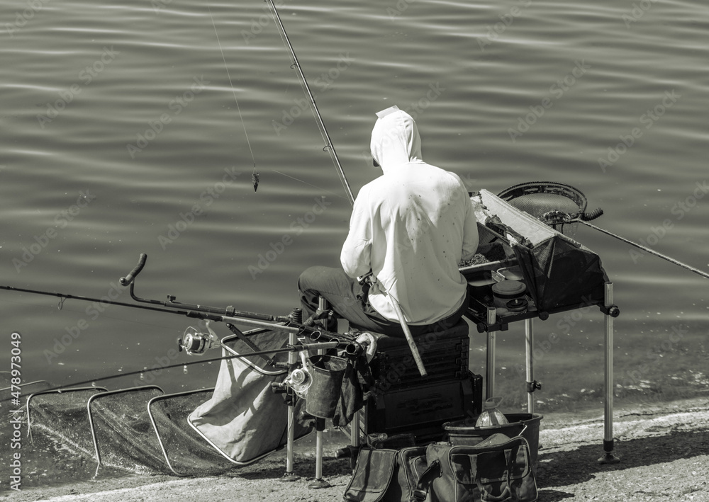 Obraz premium A man fishing with a rod