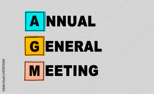 AGM - Annual general meeting abbreviation on gray background. Business concept photo