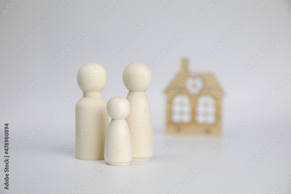 Paper figures of family near house on white background. Happy family and home concept. Parents and children's with copy space Paper figures of family near house on white background. Happy family and home concept. Parents and children's with copy space