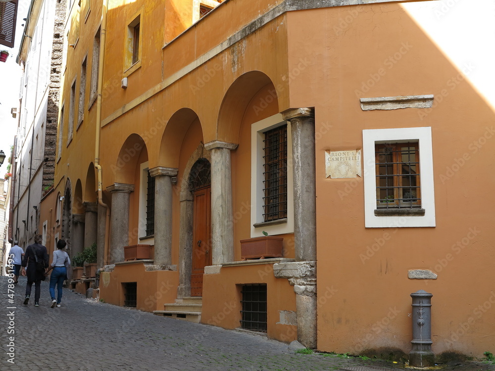 Rome Street View with Historic Orange House Facade with Ancient Columns, Italy