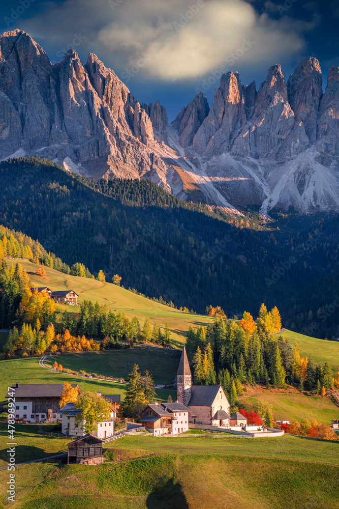 Autumn in Alps. Beautiful St. Magdalena village with magical Dolomites mountains in a gorgeous Val di Funes valley, South Tyrol, Italian Alps at autumn sunset.