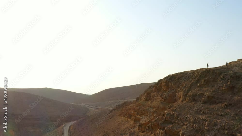 Aerial Lockdown Shot Of Tourist At Mamshit National Park Mountain During Vacation - Dimona, Israel Aerial Lockdown Shot Of Tourist At Mamshit National Park Mountain During Vacation - Dimona, Israel