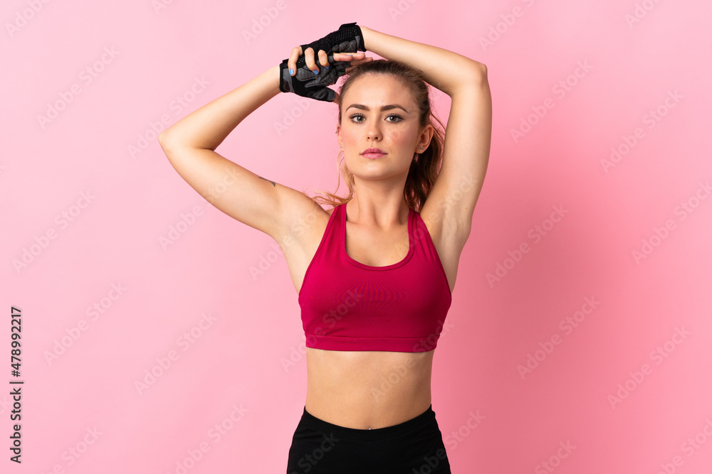 Obraz premium Young Brazilian woman isolated on pink background stretching