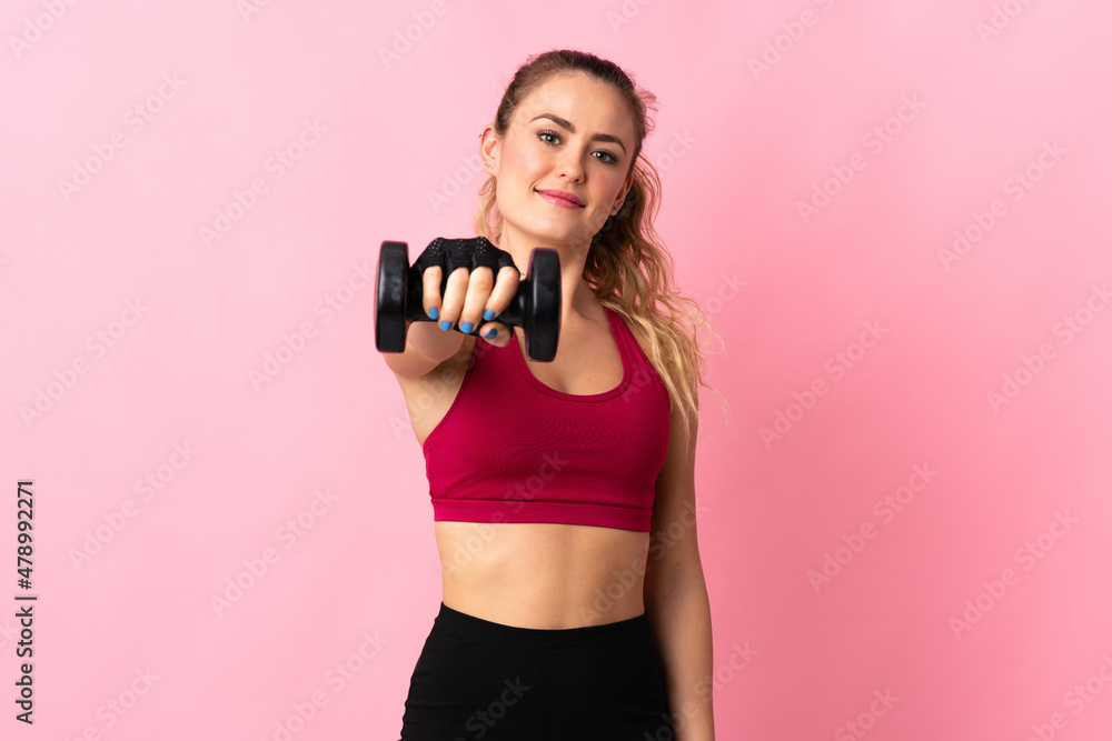 Young Brazilian woman isolated on pink background making weightlifting Young Brazilian woman isolated on pink background making weightlifting