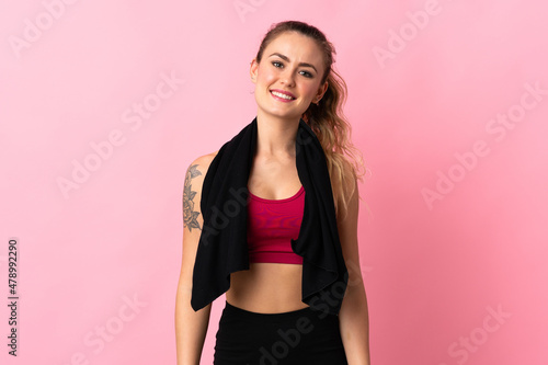 Young Brazilian woman isolated on pink background with sport towel
