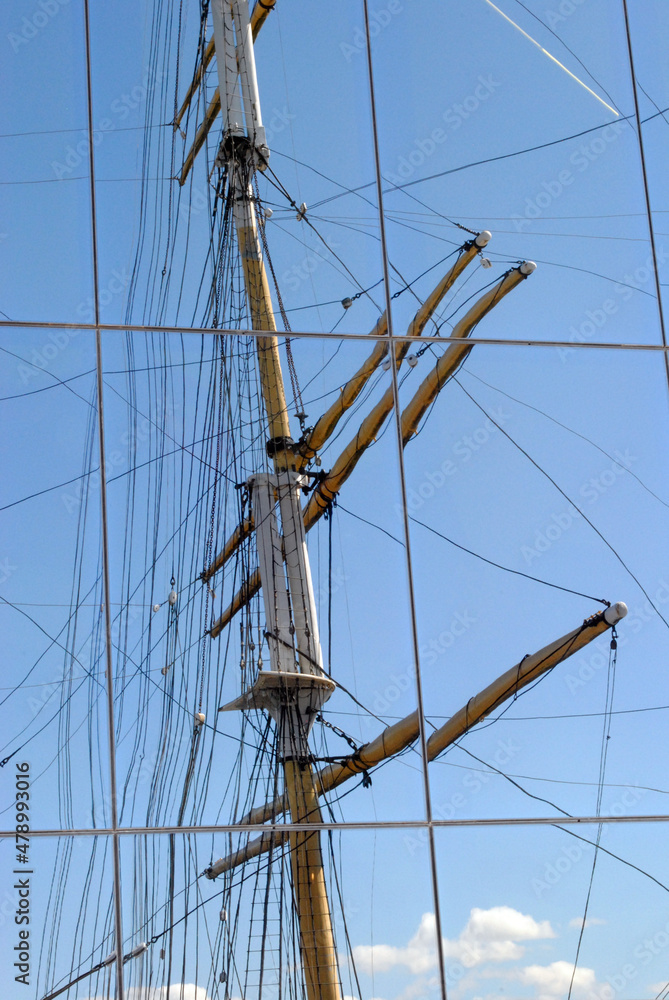 Tall Steel Mast and Ropes on Sailing Ship reflected in Glass Window Tall Steel Mast and Ropes on Sailing Ship reflected in Glass Window