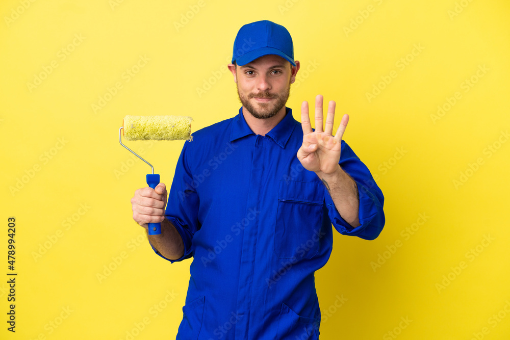 Painter Brazilian man isolated on yellow background happy and counting four with fingers Painter Brazilian man isolated on yellow background happy and counting four with fingers