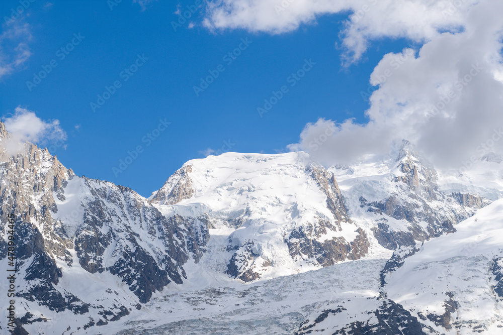 The panoramic view of Mont Blanc from Tacul in the Mont Blanc Massif in Europe, France, the Alps, towards Chamonix, in summer, on a sunny day.