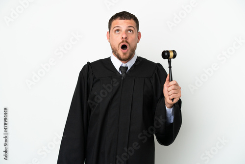 Judge caucasian man isolated on white background looking up and with surprised expression