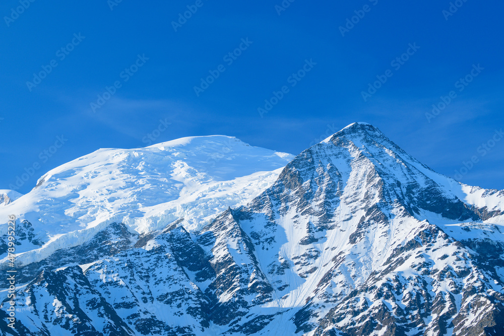 Clouds over Mont Blanc and the Aiguille du Gouter in Europe, France, the Alps, towards Chamonix, in summer, on a sunny day.