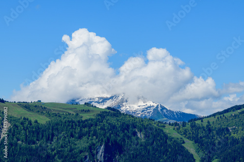 Clouds over Mont Joly and Col de Voza in the Mont Blanc Massif in Europe, France, the Alps, towards Chamonix, in summer, on a sunny day. photo